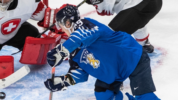Finland's Kasper Simontaival (29) is stopped by Switzerland goalie Thibault Fatton (29) 