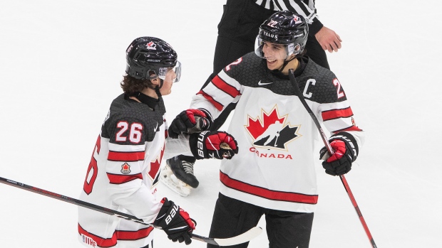 Canada's Philip Tomasino celebrates his goal with teammate Dylan Cozens