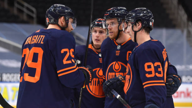 Leon Draisaitl talks with Connor McDavid, Tyson Barrie, and Ryan Nugent-Hopkins