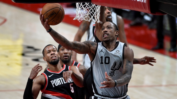 San Antonio Spurs' DeMar DeRozan attempts shot against Portland Trail Blazers