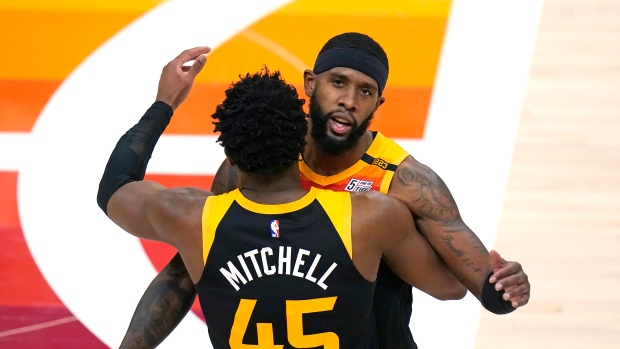 Utah Jazz's Royce O'Neale, rear, and Donovan Mitchell celebrate