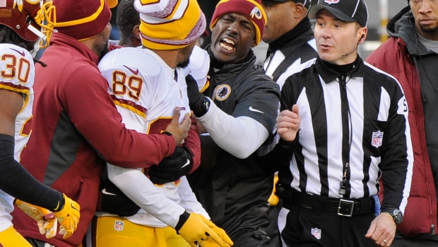 Santana Moss argues with referee