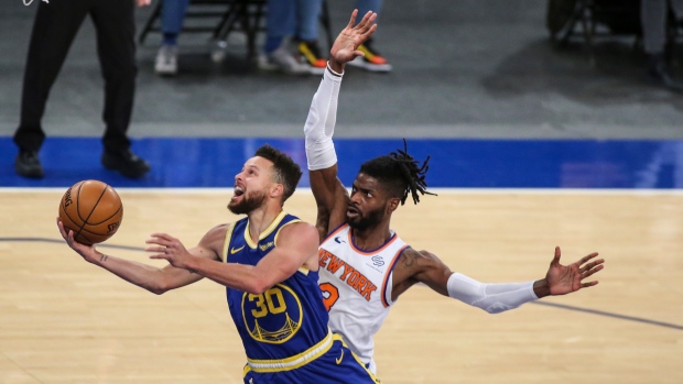 Stephen Curry moves past Nerlens Noel