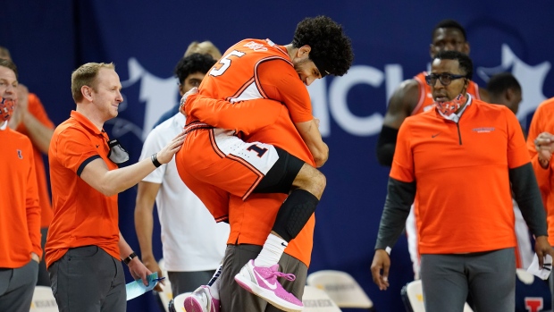 Andre Curbelo hugs head coach Brad Underwood , The Canadian Press Andre Curbelo hugs head coach Brad Underwood