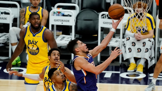 Phoenix Suns' Devin Booker scores against Golden State Warriors