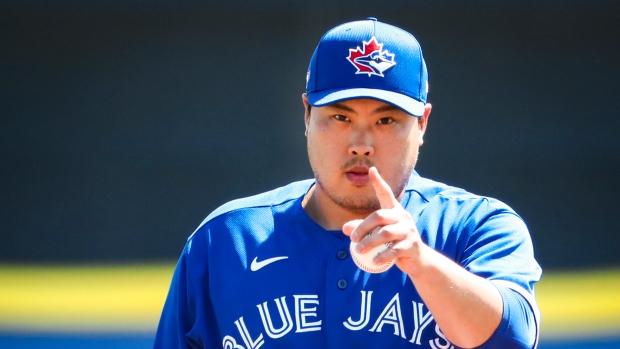 Toronto Blue Jays newly signed pitcher Hyun-Jin Ryu, right, holds