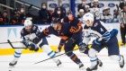 Connor McDavid (97) is chased by Derek Forbort (24) and Neal Pionk 