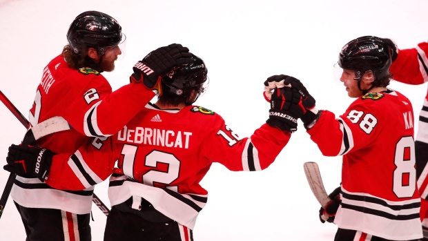 Alex DeBrincat, Duncan Keith and Patrick Kane, The Canadian Press Alex DeBrincat, Duncan Keith and Patrick Kane