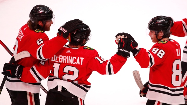 Alex DeBrincat, Duncan Keith and Patrick Kane