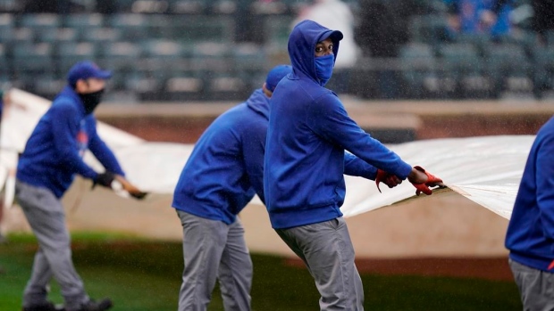 New York Mets crew works during rain delay