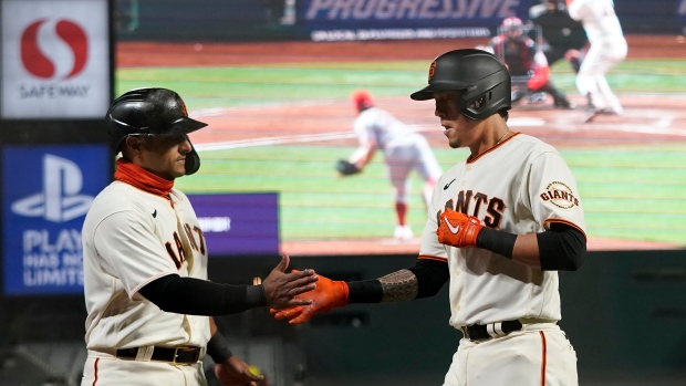 Wilmer Flores, right, is congratulated by Donovan Solano