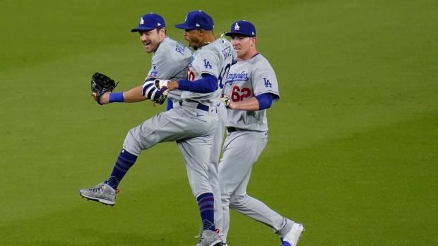 Mookie Betts, center, celebrates with right fielder Luke Raley, right, and left fielder AJ Pollock, The Canadian Press Mookie Betts, center, celebrates with right fielder Luke Raley, right, and left fielder AJ Pollock