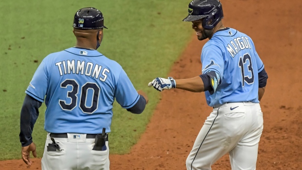 Ozzie Timmons (30) congratulates Manuel Margot (13)