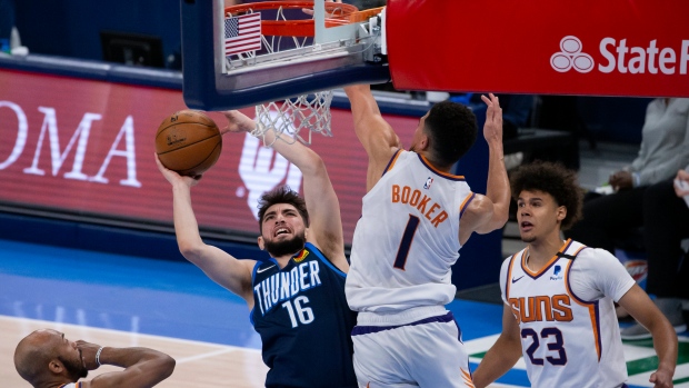 Ty Jerome shoots against Devin Booker