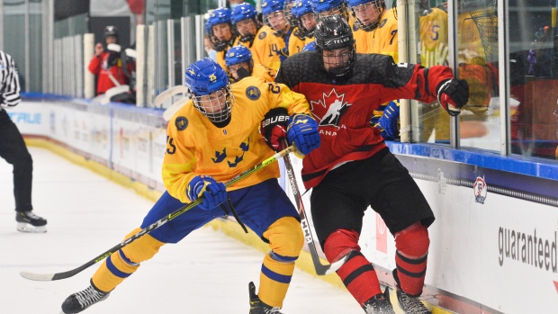 Sweden's Albert Sjoberg battles for puck possession against Canada's Nolan Allan, IIHF/HHOF Sweden's Albert Sjoberg battles for puck possession against Canada's Nolan Allan