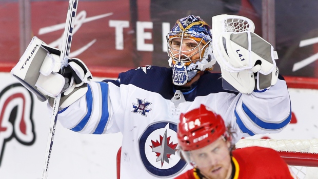 Connor Hellebuyck celebrates