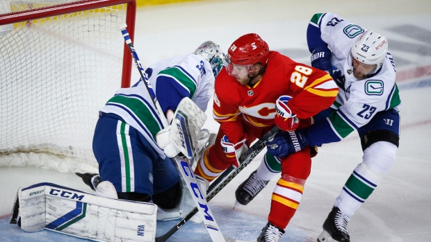 Elias Lindholm, Alexander Edler, Thatcher Demko, The Canadian Press Elias Lindholm, Alexander Edler, Thatcher Demko