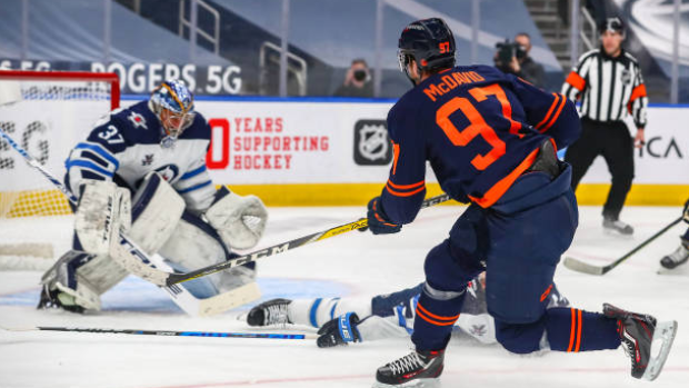 Connor McDavid shoots on Connor Hellebuyck, Getty Images Connor McDavid shoots on Connor Hellebuyck