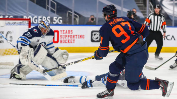 Connor McDavid shoots on Connor Hellebuyck