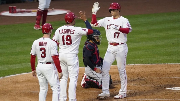 Shohei Ohtani celebrates with Juan Lagares and Taylor Ward, The Canadian Press Shohei Ohtani celebrates with Juan Lagares and Taylor Ward