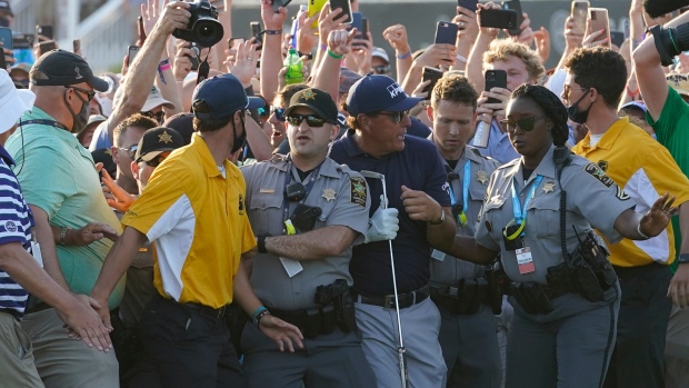 Phil Mickelson tries to get through the crowd