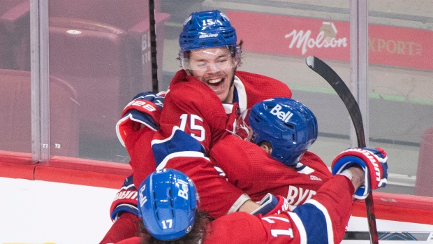 Jesperi Kotkaniemi (15) celebrates with teammate Paul Byron and Josh Anderson (17)