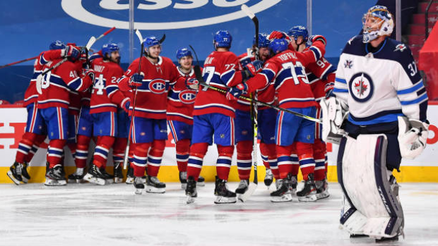 Connor Hellebuyck skates off as Canadiens celebrate, Getty Images Connor Hellebuyck skates off as Canadiens celebrate