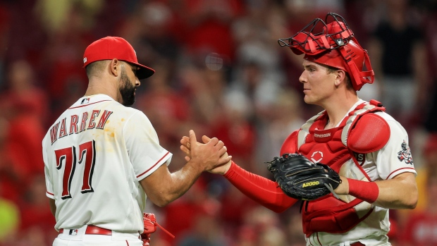 Art Warren, left, shakes hands with Tyler Stephenson