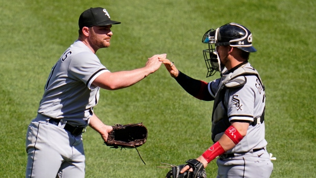 Liam Hendriks and catcher Yasmani Grandal, The Canadian Press Liam Hendriks and catcher Yasmani Grandal