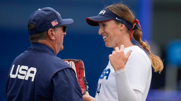 United States head coach Ken Eriksen celebrates with Monica Abbott