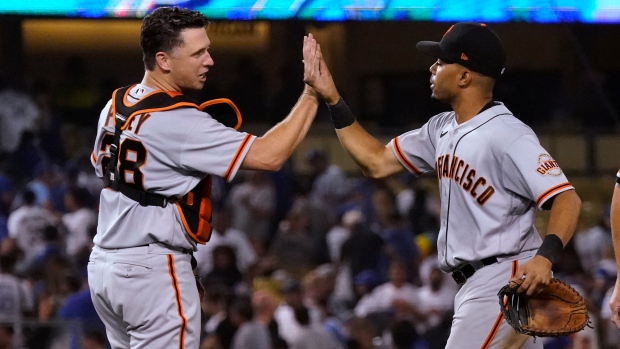 LaMonte Wade Jr. and Buster Posey, The Canadian Press LaMonte Wade Jr. and Buster Posey