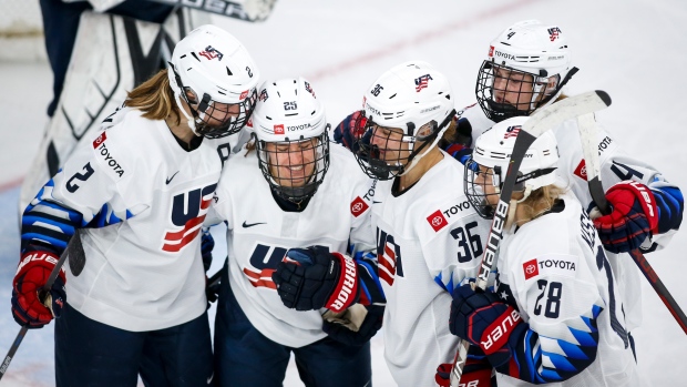 Alex Carpenter (25) celebrates with team USA teammates