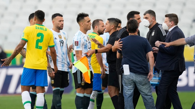 Brazil and Argentina's player talk as the soccer game is interrupted by health authorities 