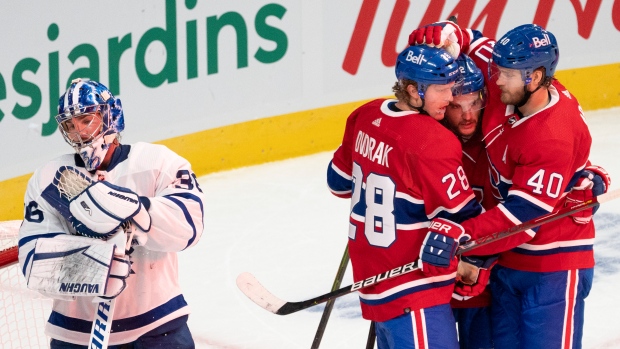 Christian Dvorak,  Jonathan Drouin and Joel Armia celebrate