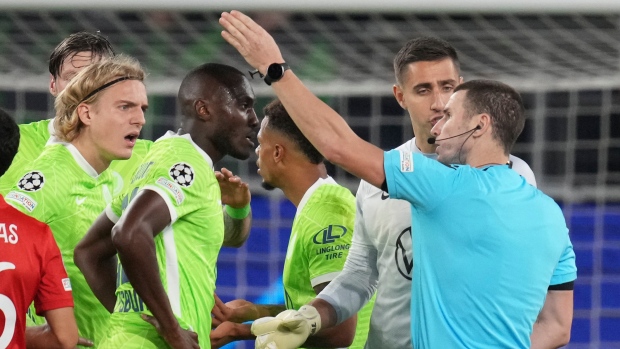 Referee talks to Wolfsburg's Josuha Guilavogui