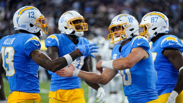 Los Angeles Chargers quarterback Justin Herbert and team celebrates 