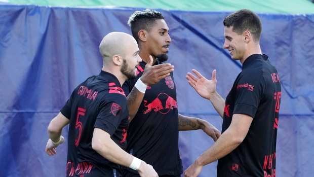 Fabio Gomes Netto, center, celebrates with Andrew Gutman (5) and Sean Nealis