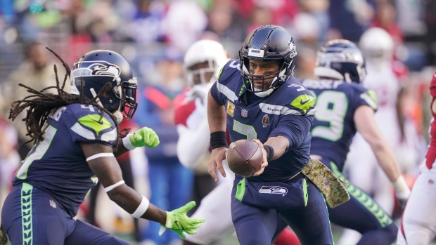 Alex Collins Russell Wilson, The Canadian Press Alex Collins Russell Wilson