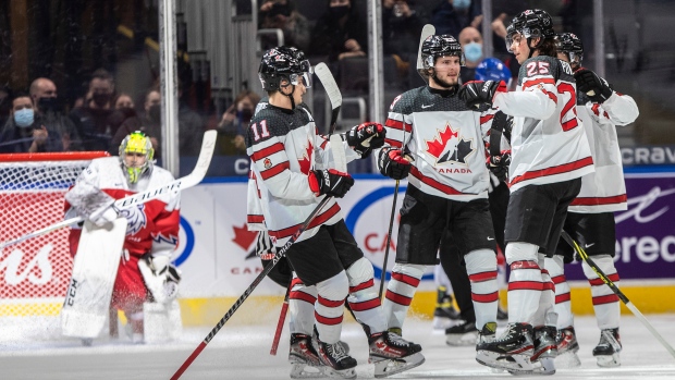 Jakub Malek Cole Perfetti (11), Mason McTavish (23) and Owen Power (25)