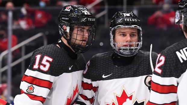 Connor Bedard celebrates with Shane Wright (right) and Jake Neighbours