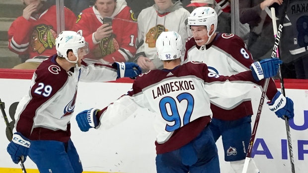 Chicago Blackhawks center Kirby Dach, right, celebrates his tying