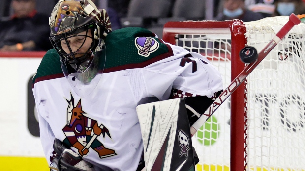 Arizona Coyotes goaltender Karel Vejmelka wears a helmet decorated with a  cross and a flag of the Czech Republic in an NHL hockey game against the  Seattle Kraken, Thursday, April 6, 2023