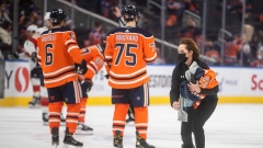 Skater removes Oilers jerseys from the ice
