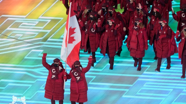 Canada flag-bearers Charles Hamelin (left) and Marie-Philip Poulin