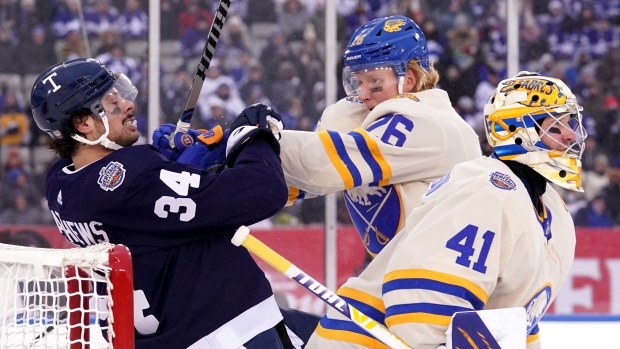Morgan Rielly of the Toronto Maple Leafs cross checks Rasmus Dahlin News  Photo - Getty Images