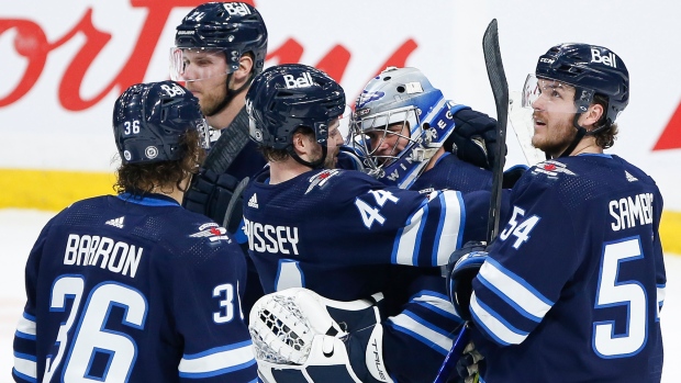 Winnipeg Jets celebrate Eric Comrie