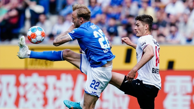 Hoffenheim's Kevin Vogt, left, and Leverkusen's Patrik Schick