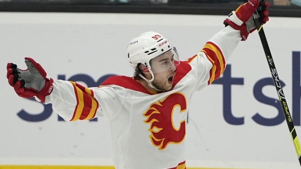 Calgary Flames Right Wing Andrew Mangiapane adjusts his jersey before