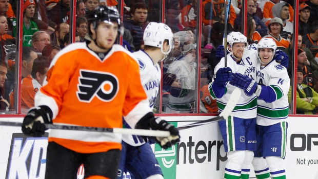 Canucks celebrate in front of Matt Read