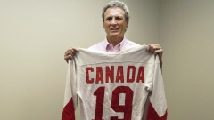 Paul Henderson holds No. 19 sweater